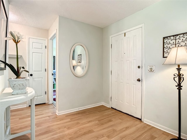 966 N Ronald Reagan Blvd, Longwood, FL 32750 - foyer with light wood-style flooring, a textured ceiling, and baseboards
