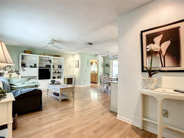 966 N Ronald Reagan Blvd, Longwood, FL 32750 - living area with a ceiling fan, light wood-style floors, and baseboards