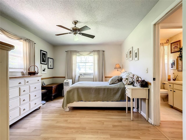 966 N Ronald Reagan Blvd, Longwood, FL 32750 - bedroom with light wood-type flooring, a textured ceiling, ensuite bath, and ceiling fan