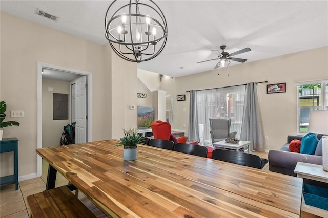 dining area featuring light tile flooring and ceiling fan with notable chandelier