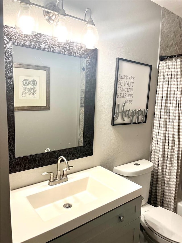 bathroom with toilet and vanity