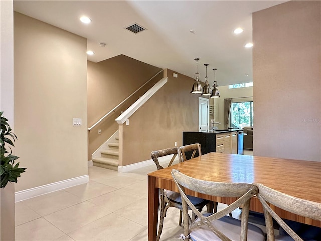 dining area with light tile floors and sink