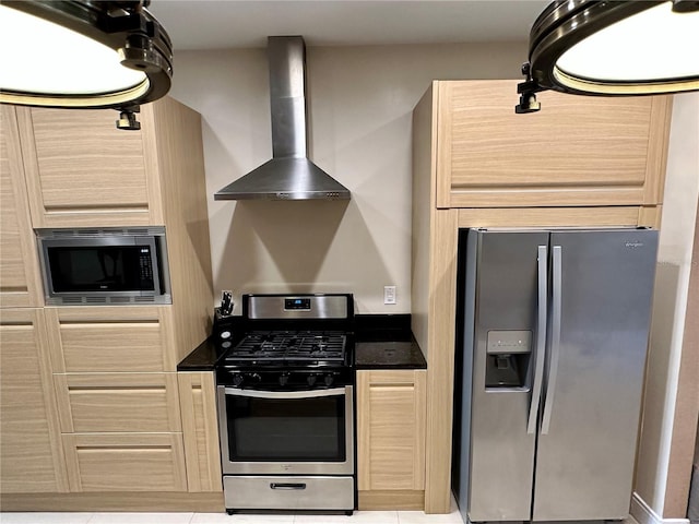 kitchen featuring light tile floors, wall chimney exhaust hood, light brown cabinetry, and stainless steel appliances