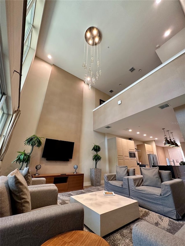 living room featuring a notable chandelier and a towering ceiling