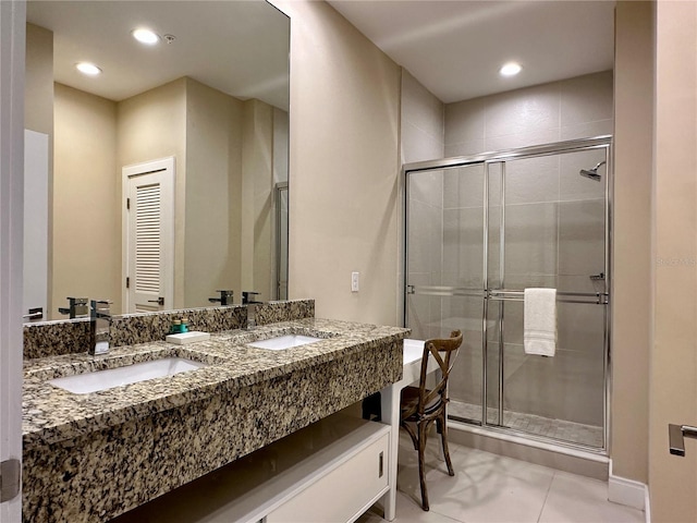 bathroom with dual vanity, tile flooring, and walk in shower