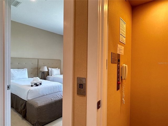 carpeted bedroom with a textured ceiling