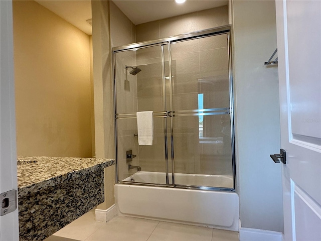 bathroom featuring vanity, shower / bath combination with glass door, and tile floors