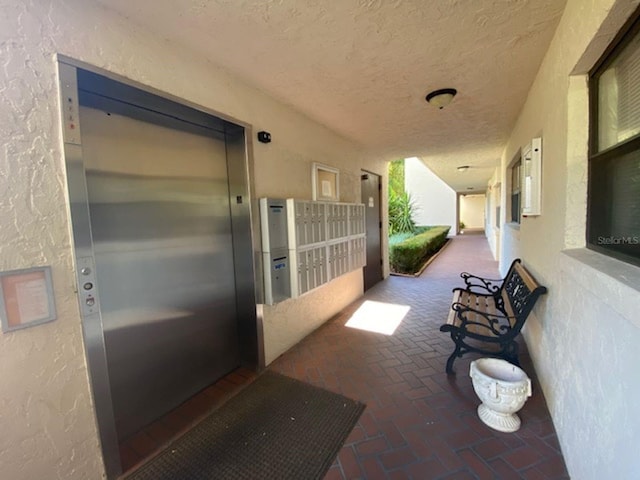 exterior space featuring a mail area and elevator