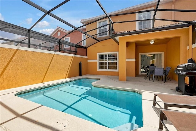 view of swimming pool featuring a patio area, area for grilling, and glass enclosure