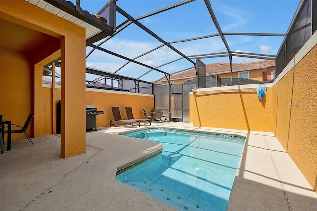 view of swimming pool with a patio and glass enclosure