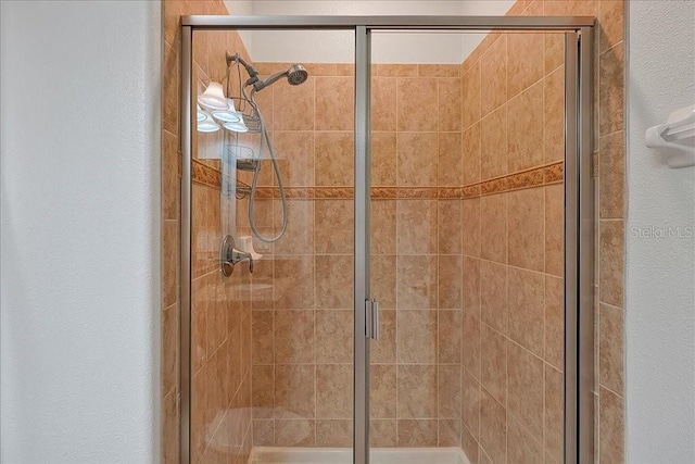 bathroom featuring a shower with door