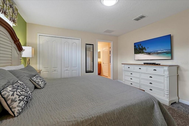 carpeted bedroom featuring a closet and a textured ceiling