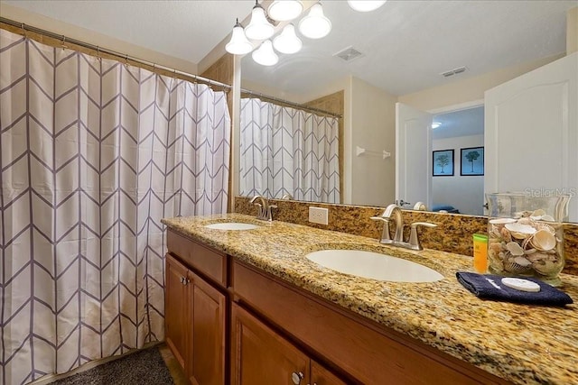 bathroom featuring an inviting chandelier, double sink, and large vanity