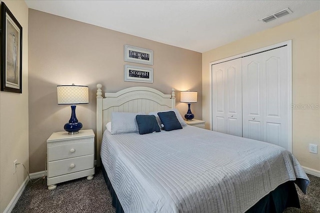 bedroom featuring a closet and dark colored carpet