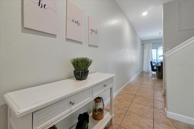 corridor featuring light tile floors