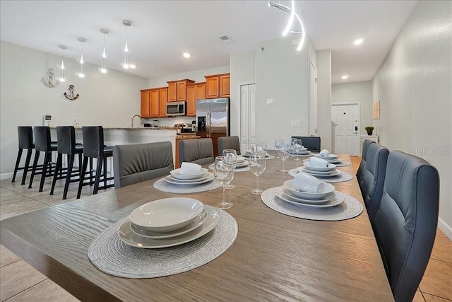 tiled dining room with sink