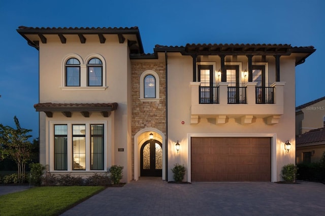 mediterranean / spanish house with a balcony and a garage