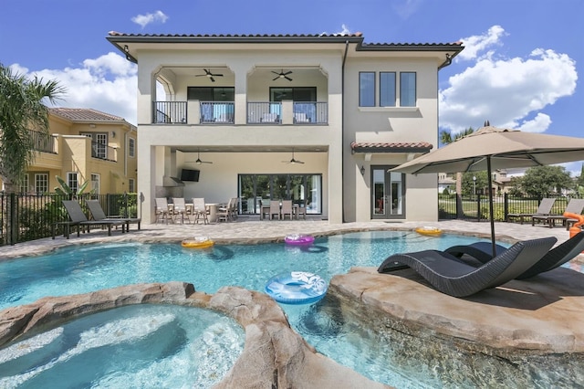 view of swimming pool with a patio and an in ground hot tub