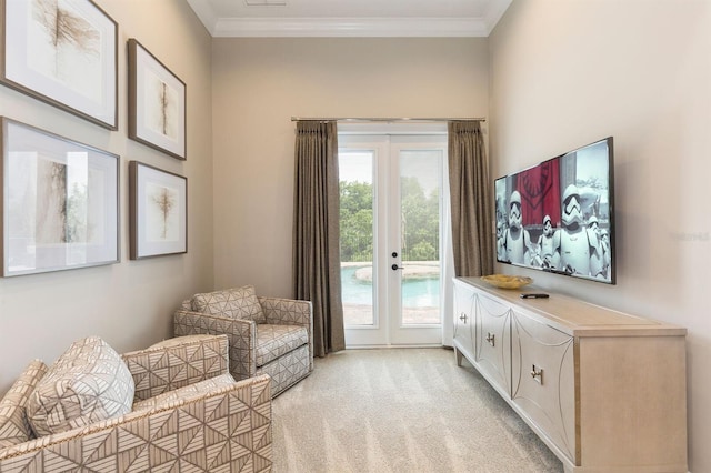 living area with crown molding, light colored carpet, and french doors