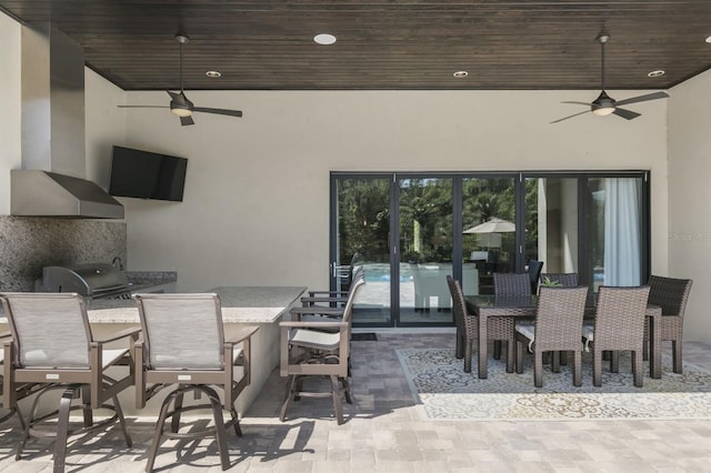 view of patio / terrace with ceiling fan, a grill, and exterior kitchen