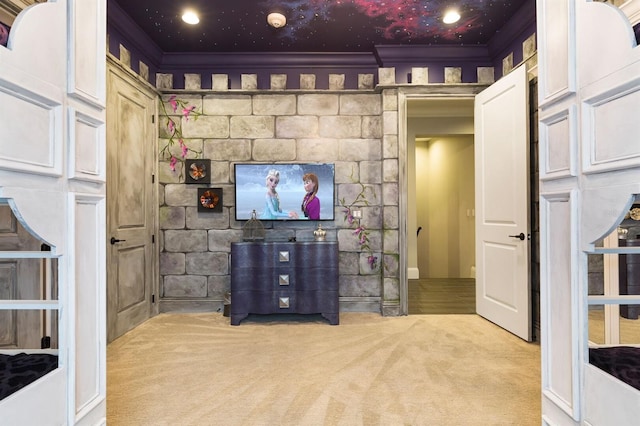 interior space featuring crown molding and light colored carpet