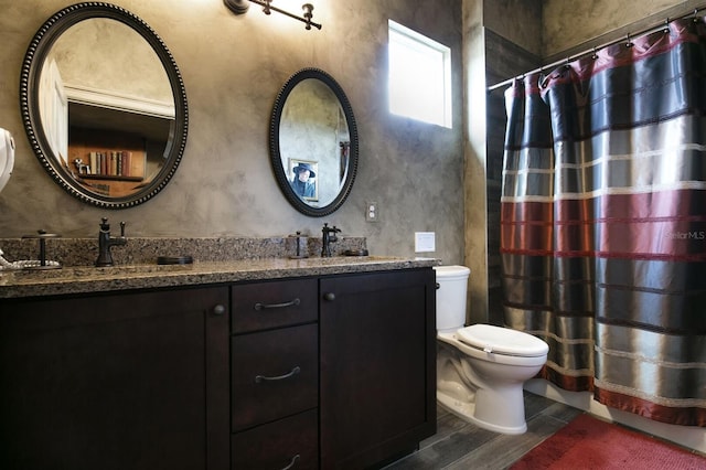 bathroom with wood-type flooring, vanity, toilet, and a shower with shower curtain