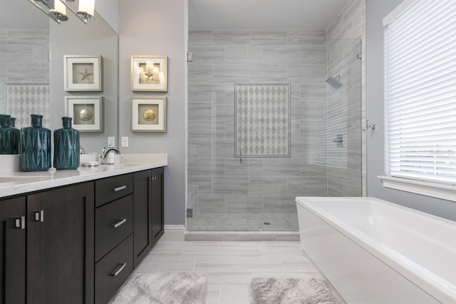 bathroom featuring vanity and shower with separate bathtub