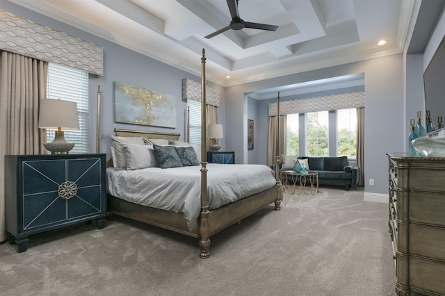 bedroom with carpet floors, crown molding, a tray ceiling, and ceiling fan