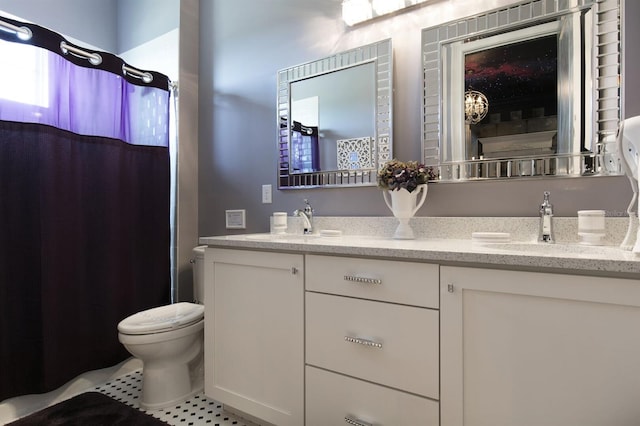 bathroom with tile patterned floors, vanity, and toilet