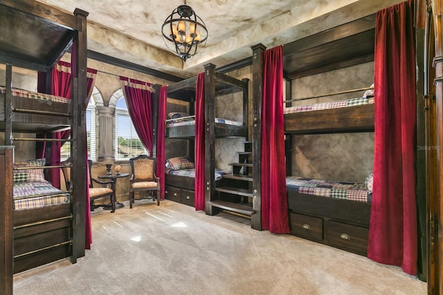 bedroom with an inviting chandelier and carpet flooring