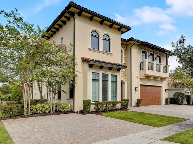 mediterranean / spanish-style house with a balcony and a garage