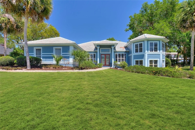 mediterranean / spanish home with a front yard