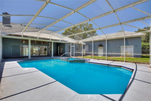 view of swimming pool featuring a patio area, an in ground hot tub, and a lanai