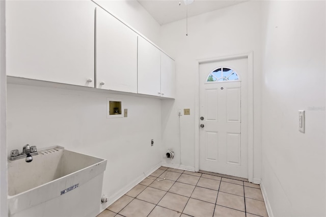 laundry area with washer hookup, hookup for an electric dryer, sink, light tile floors, and cabinets