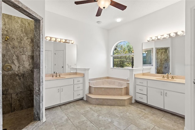 bathroom featuring vanity with extensive cabinet space, dual sinks, tile floors, and ceiling fan