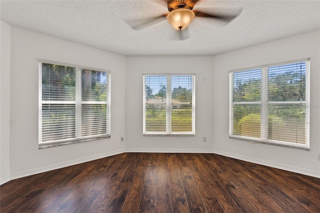 spare room featuring dark hardwood / wood-style flooring, a textured ceiling, and ceiling fan