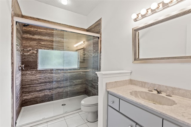 bathroom featuring toilet, an enclosed shower, tile floors, a textured ceiling, and large vanity