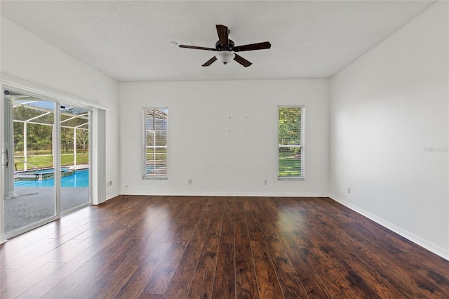 spare room featuring ceiling fan and dark hardwood / wood-style floors