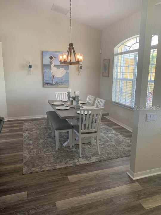 dining room with an inviting chandelier and dark hardwood / wood-style flooring