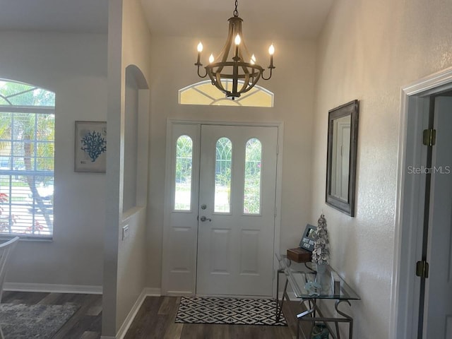 foyer with a notable chandelier and dark hardwood / wood-style flooring