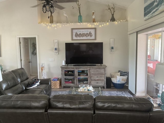 living room featuring ceiling fan and lofted ceiling