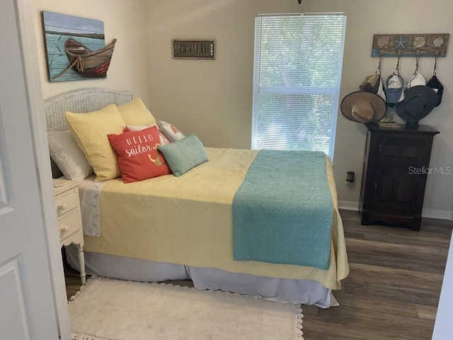 bedroom with dark wood-type flooring