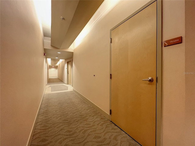 hall with light colored carpet