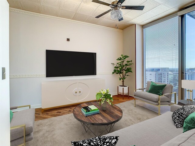 living room with ceiling fan, floor to ceiling windows, and hardwood / wood-style floors