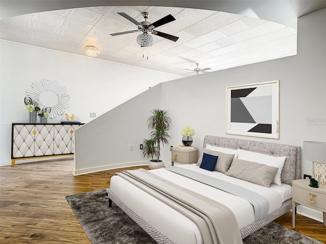 bedroom with ceiling fan, lofted ceiling, and hardwood / wood-style floors