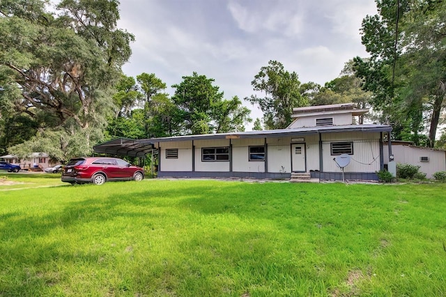 back of house with a yard and a carport