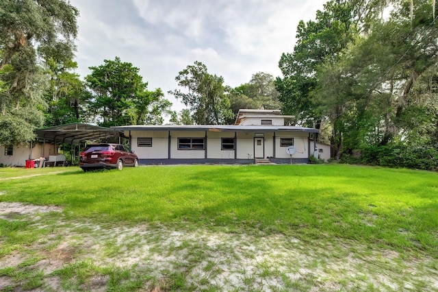 exterior space with a carport and a front yard