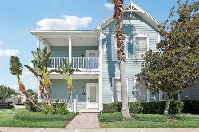 view of front facade featuring a balcony and covered porch