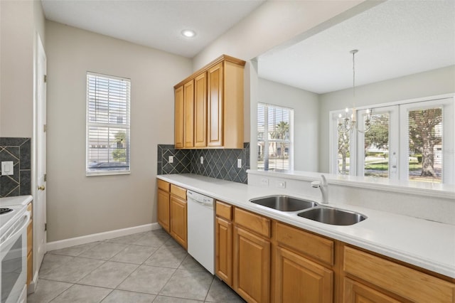 kitchen featuring sink, hanging light fixtures, tasteful backsplash, white appliances, and light tile patterned floors