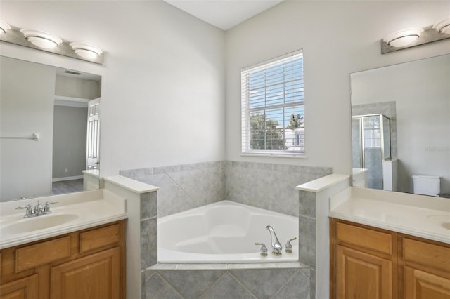 full bathroom with vanity, toilet, and plus walk in shower